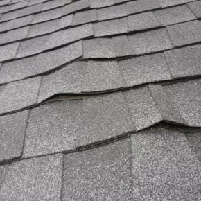 Buckled shingles on roof